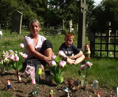family visiting a grave