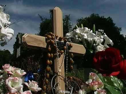 wooden cross and flowers